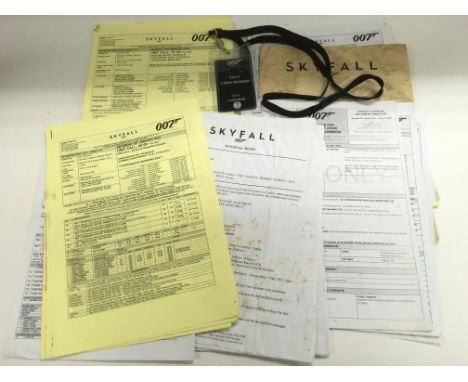 A collection of James Bond Skyfall props and memorabilia comprising a splinter unit call sheet, crew member laminate, props i