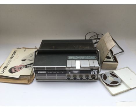 A vintage Uher 4000 portable reel to reel recorder with manual and accessories.
