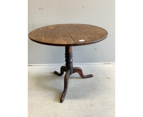 A George III circular oak tilt top tripod table, diameter 82cm, height 70cm. Condition - fair