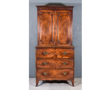 A George III Mahogany Secretaire Bookcase, the upper part with dentil moulded cornice, four shelves enclosed by a pair of pan