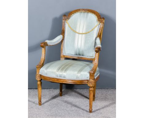 A 19th Century French Beech Wood Framed Armchair, the moulded frame carved with flowers, the back, seat and arms upholstered 