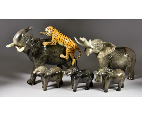 A Beswick Elephant and Tiger, model No.1720, 12ins high, another of a trumpeting elephant, 11.75ins high, and five other mode