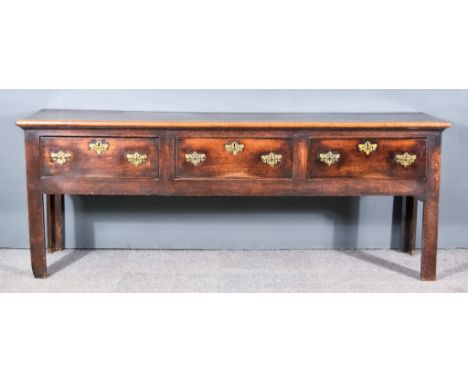 An 18th Century Oak Dresser Base, with plain two plank top, and moulded edge, fitted three frieze drawers, plain apron and on