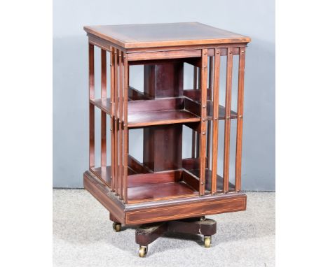 An Edwardian Figured Mahogany and Satinwood Strung Two Tier Square Revolving Bookcase, with satinwood marquetry, quarter vene