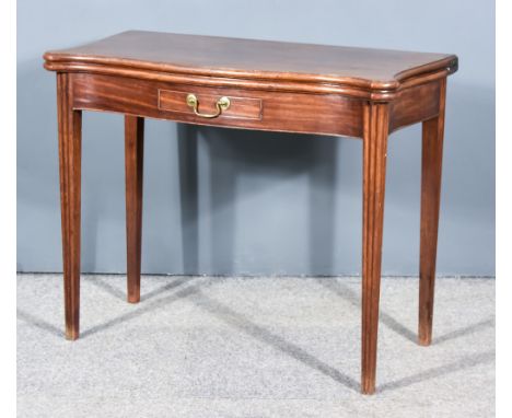 A George III Mahogany Rectangular Tea Table of serpentine outline, with moulded edge to top, fitted one frieze drawer and on 