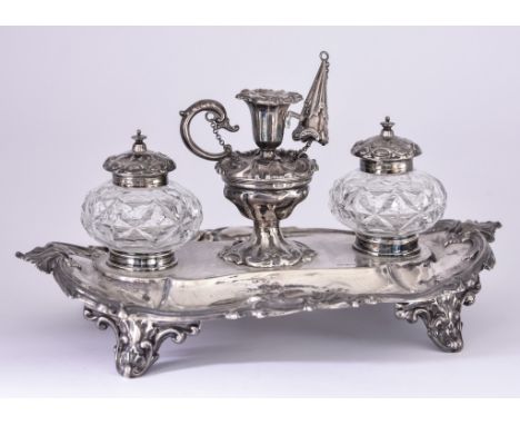 A Late Victorian Silver Oval Ink Stand, by Walker & Hall, Sheffield 1900, the shaped rim with chased and leaf scroll cast mou