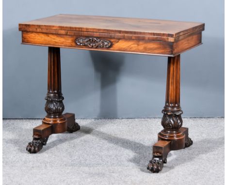 A George IV Rosewood Rectangular Card Table, with square edge to the baize lined folding top, the frieze with carved leaf and