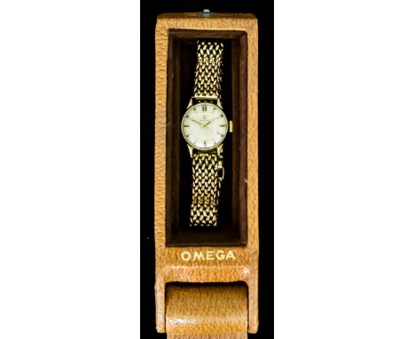 A 9ct Gold Manual Wind Lady's Wristwatch by Omega, 9ct gold case with conforming bracelet, silver dial with gold baton numera