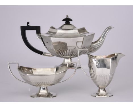 A George V Silver Octagonal Three-Piece Tea Service, by H.L.B. Sheffield 1923, with part fluted bodies, angular handles and u