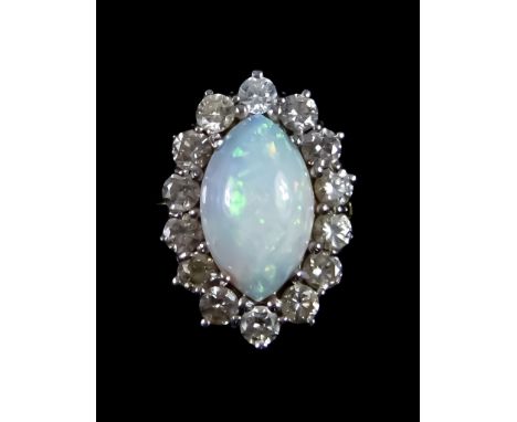 An 18ct Gold Opal and Diamond Ring, set with a centre elongated opal, 11mm x 6mm, surrounded by brilliant cut small white dia