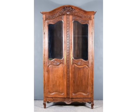 A 19th Century French Provincial Oak Armoire, with moulded cornice, the frieze carved with vase of flowers and fruiting vines