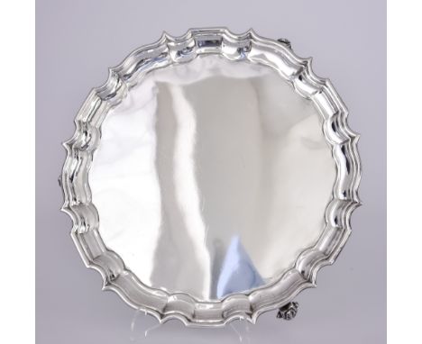 A Late Victorian Silver Circular Salver, by Mappin Brothers, London 1898, with shaped and moulded rim on three bold leaf capp