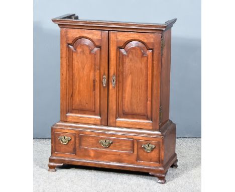 A George III Mahogany Spice Cupboard, the upper part with moulded cornice, fitted fifteen small drawers, enclosed by a pair o