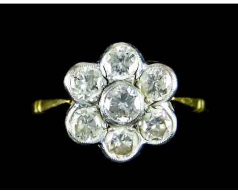 An 18ct Gold Diamond Cluster Ring, set with seven diamonds in a flower head design, approximately 1.5ct, size N, gross weight