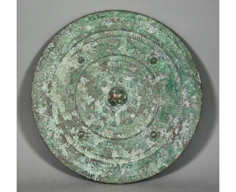 A Chinese Patinated Bronze Circular Mirror with Plain Face, of Early Archaic Form, the reverse cast in relief with figures of