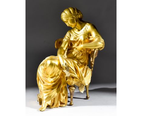 A French Gilt-Bronze Figure of a Seated Lady, 2nd Half of 19th Century, in Greek classical dress, holding an oil lamp, 10ins 