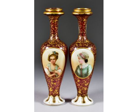 A Pair of 19th Century Bohemian Ruby Glass and White Overlay Vases, each with scrolling foliate gilding and oval reserve pane