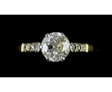 An 18ct Gold and Platinum Diamond Ring,&nbsp;&nbsp;set with a centre brilliant cut white diamond, approximately 1ct, flanked 