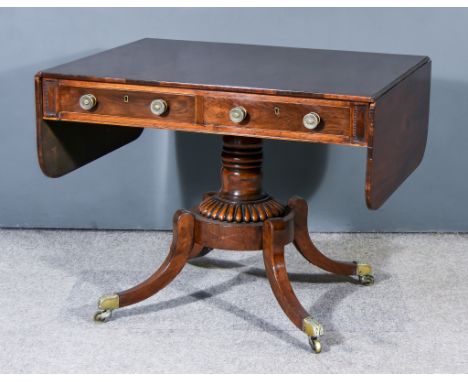 A George IV Mahogany Sofa Table, fitted two real and two dummy frieze drawers, turned central column with reeded base, on fou