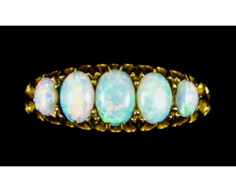 An 18ct Gold Five Stone Opal Ring, 20th Century, set with five cabochon opals, size P, gross weight 4.1g