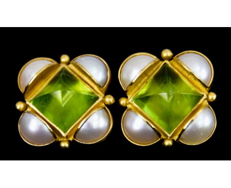 A Pair of 22ct Gold Earrings, for pierced ears, set with faceted peridot stones to the centre surrounded by quadrant of pearl