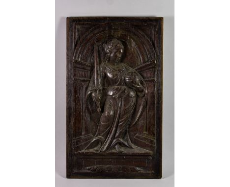 A Carved Oak Panel, Late 16th Century, possibly French, of a standing female figure holding a sword and orb, within an archit
