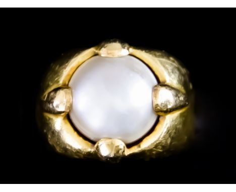 A Yellow Metal Ring, set with a button pearl, size M, gross weight 11.9g Note: Ring marked 850 Images are within the attached
