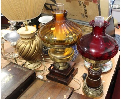 A 20th century brass converted oil lamp and shade, height 52cm, together with another similar and a gilt table lamp and shade