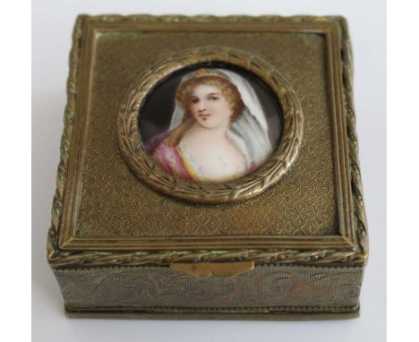A 19th century brass trinket box with inset painted porcelain plaque to the lid decorated with a portrait of a young lady, 7x