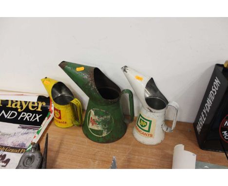 Three various vintage oil pourers, to include a BP Lubricants, Shell Lubricants, and a Castrol example, all in worn condition