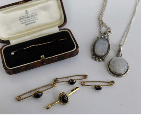 Four various yellow metal and black onyx set safety pin brooches, one stamped 9ct the others unmarked, gross weight 7.5g toge