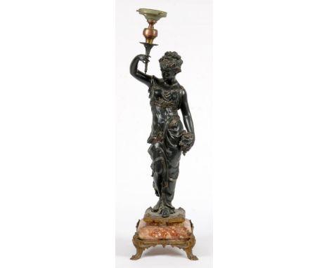 A FIN DE SIECLE SPELTER FIGURAL LAMP IN THE FORM OF A LADY HOLDING ALOFT A TORCH, ON MARBLE BASE AND GILTMETAL FEET, 77CM H, 