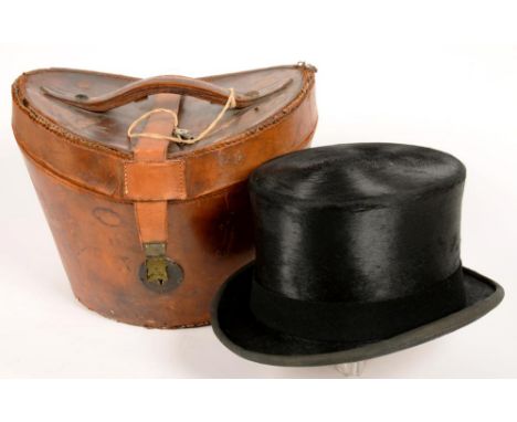A GENTLEMAN'S BLACK SILK TOP HAT BY LOCK &amp; CO, HEAD APERTURE 20.5 X 17CM, IN EARLIER LEATHER HAT BUCKET AND AN EARLY 20TH