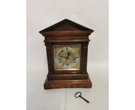 Circa 1900 brass faced and oak cased wind up chiming mantel clock, with pendulum and key. 43cm high, 19cm deep and 31cm wide.