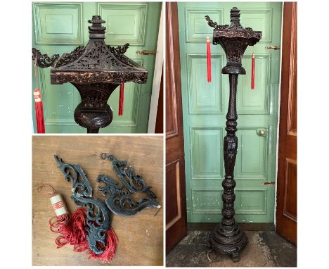 An Oriental hardwood standing lamp, damages to top shade, some pieces missing and previously glued, some pieces still with li
