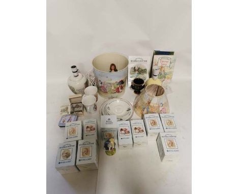 A collection of Beatrix Potter related items to include 11 boxed figures, a table lamp and shade, a waste paper bin and other