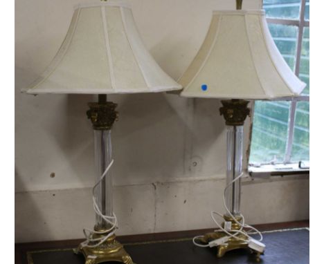 A pair of glass and brass imitation table lamps with shades, approximately 78cm high each. together with another brass effect