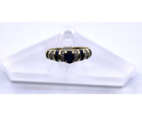 14ct Yellow Gold Sapphire & Diamond dress ring.  There is an Oval Brilliant Cut Sapphire in the centre of the ring that measu