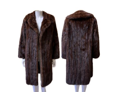 Two vintage coats to include one mid-length dark and glossy mink with lapels and furrier hook fastening to fit a size S along