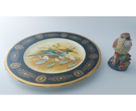 A Coalport artist's sample plate painted with a bee-eater by R. Blyth within a black and gilt foliate border, printed marks, 