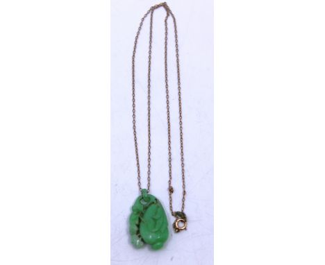 Carved Jade Pendant suspended on a 9ct Rose Gold Fine Chain.  The Jade Pendant is in the shape of a Peach with foliage.  The 