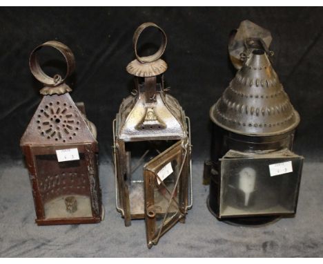 An early19th century tinplate lantern with pierced domed top, loop carrying and suspension loop, glazed panel, 30.5cm high, a