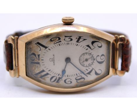 Rare 1912 Unmarked Gold Omega Wristwatch with brown crocodile leather strap.  The watch face is Tonneau-shaped and curved. It