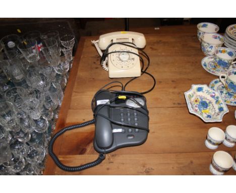 A modern dial telephone and a rotary telephone