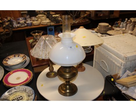 A brass oil lamp converted to electricity and two table lamps