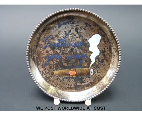 A white metal dish marked 900 to the back and "Gentlemen you may" in blue enamel with a cigar beneath (diameter 7.5cm)