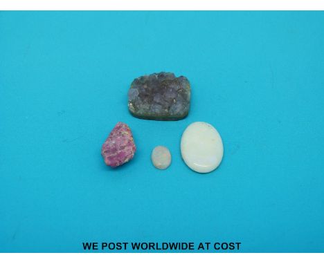 Two oval opal cabochons and a section of amethyst geode 