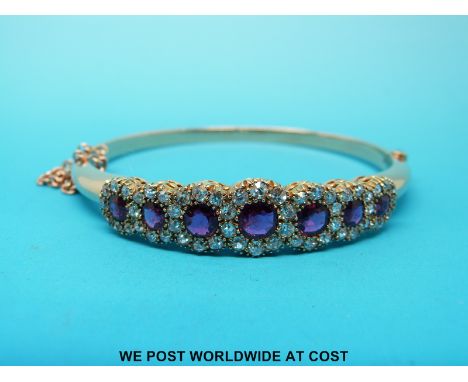 An Art Deco bangle/ bracelet set with seven round cut rubies surrounded by diamonds (largest ruby approx 0.5ct) With copy of 