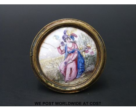 An 18thC English Bilston enamel circular cloak pin or chimney piece knob polychrome decorated with a lady seated in a garden 