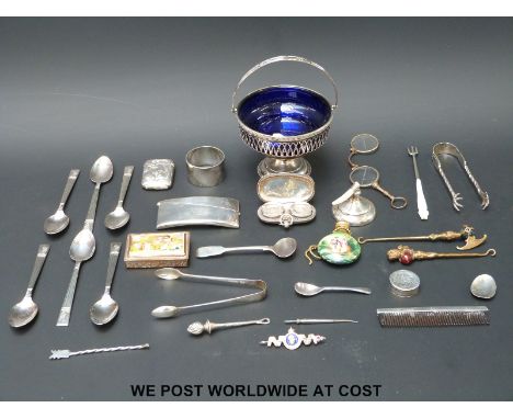 A hallmarked silver swing-handled basket with blue glass liner (11cm diameter), a hallmarked silver double sovereign case, a 